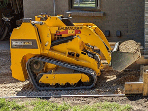 BaumaLight TRL620Y stand on compact mini loader