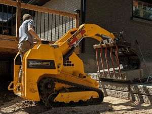 BaumaLight TRL620Y stand on compact mini loader